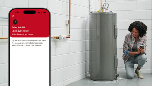 A homeowner checks her water heater for leaks using the Resideo Connect app on her smartphone.