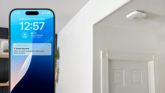 A smart phone shows the Resideo Connect app smoke detection notifications.