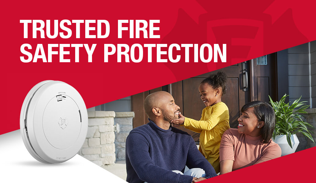 Trusted fire safety protection. A family of three sit outside their home.