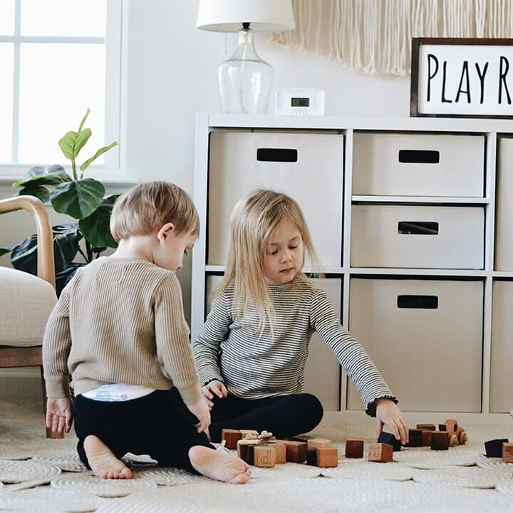 Two children playing with toy blocks